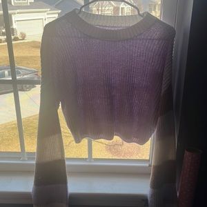 purple sweater with brown and white striped sleeves